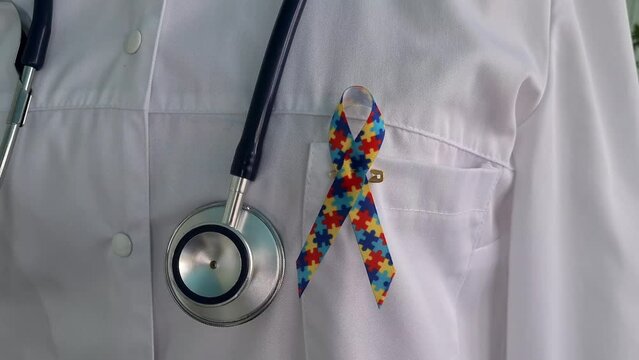 World Autism Awareness and Pride Day with ribbon with puzzle pattern. Autism causes symptoms of disease