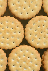 Detailed picture of round sandwich cookies with coconut filling. Background image of a close-up of several treats for tea