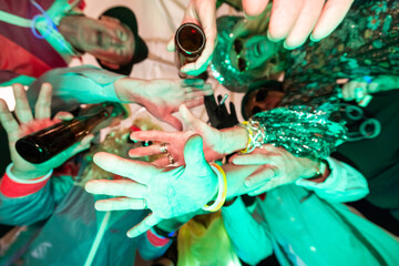 This image bursts with vibrant energy as a cluster of hands, adorned with colorful glow bracelets...