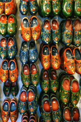 Fototapeta na wymiar Dutch wooden shoes or wooden clogs, famous symbol of Netherlands, hanged in the shop