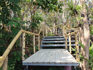 Wooden steps up the shelter surrounded by green nature.