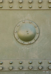 The texture of the wall of the tank, made of metal and reinforced with a multitude of bolts and rivets. Images of the covering of a combat vehicle from the Second World War