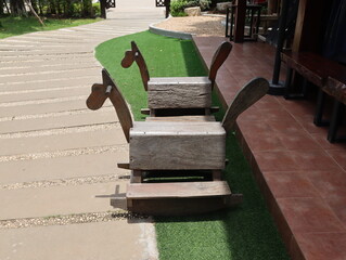 Wooden rocking horse chair for children in the playground.