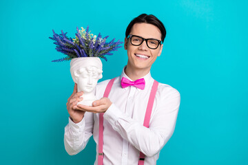 Photo portrait of pretty young male hold antique head vase flowers wear trendy pink outfit isolated...