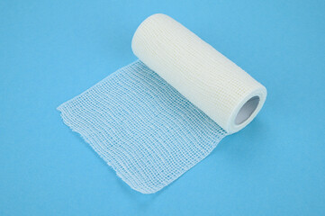 Self-fixing cohesive bandage, on a blue background.