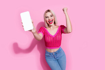 Photo of optimistic ecstatic woman with bob hair dressed knit top demonstrate smartphone display...