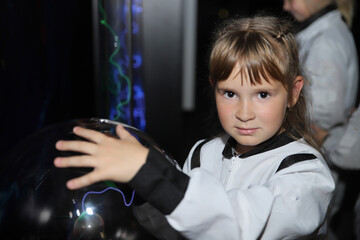 Little girl in white cosmonaut costume