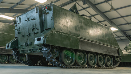 An armored personnel carrier. The rear ramp of the armored personnel carrier for boarding and unloading troops. An old tracked tank. Outdated armament of the army.