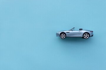 Blue toy car isolated on blue background. After some edits.