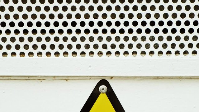 Yellow electrical Hazard triangular warning sign with bold iconography