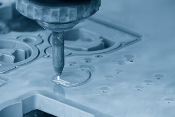 The abrasive waterjet cutting machine in the light blue scene.