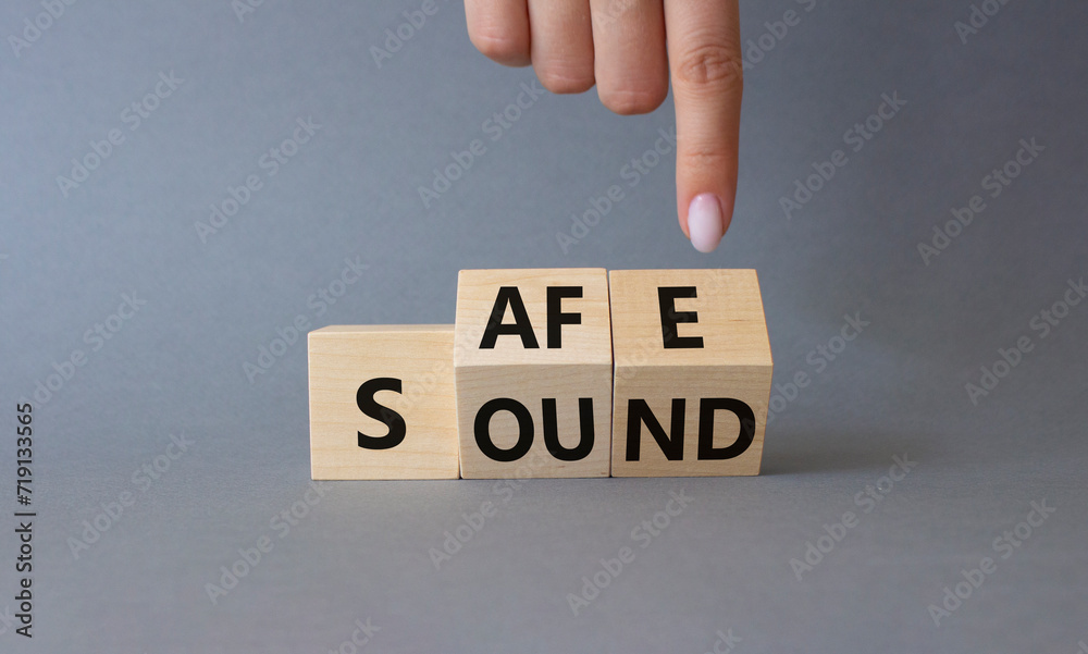 Fototapete safe and sound symbol. businessman hand points at cubes with words safe and sound. beautiful grey ba