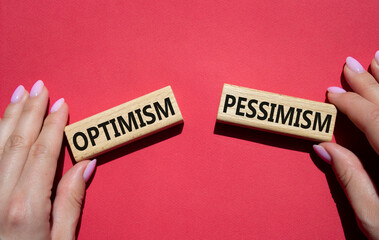Optimism or Pessimism symbol. Concept word Optimism or Pessimism on wooden blocks. Businessman...