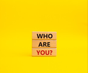 Who are You symbol. Concept words Who are You on wooden blocks. Beautiful yellow background....