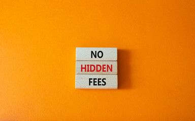 No hidden fees symbol. Concept word No hidden fees on wooden blocks. Beautiful orange background....