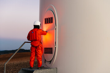 Spaceman standing in front of door in white metal building