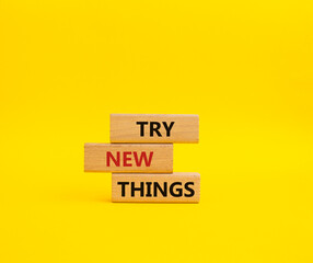 Try new Things symbol. Concept words Try new Things on wooden blocks. Beautiful yellow background. Business and Try new Things concept. Copy space.