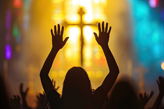 Person Raising Hands in Front of Cross
