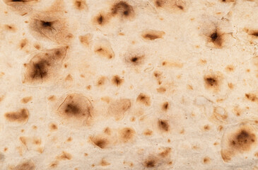 Thin pita bread texture background. Armenian pita bread unleavened flat bread. Top view. Freshly baked homemade oriental bread. Lavash as a textured bread background.