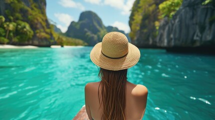 Fototapeta na wymiar Beautiful young woman in swimsuit and straw hat sunbathing and vacationing in the islands . Girl enjoys vacation and travels in a seaside resort, overlooking the mountains 