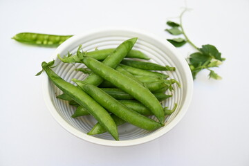 Fresh green pea isolated on white background. There is a lot of vitamins  and Minerals in it. The pea is most commonly the small spherical seed or the seed. Popular vegetable of all over world. 