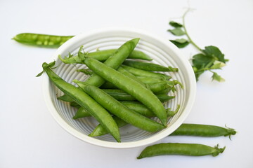 Fresh green pea isolated on white background. There is a lot of vitamins  and Minerals in it. The pea is most commonly the small spherical seed or the seed. Popular vegetable of all over world. 