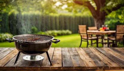Fotobehang BBq grill in the back yard background with empty wooden table © Melvin