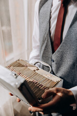 A man in a suit and tie is holding a case with money