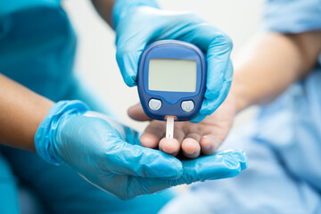 Doctor check diabetes from finger blood sugar level with finger lancet.