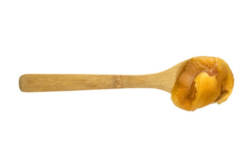 Fresh bee honey in a wooden spoon isolated
