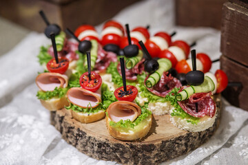Food at event. Assorted Canapés on Rustic Wooden Platter