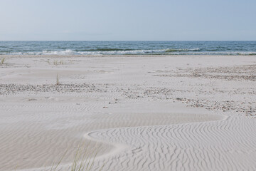 Beautiful landscapes of sand dunes against the background of the ocean. Wavy sand background, dunes and views in Slowinski National Park, Leba, Poland. 