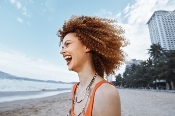 Smiling woman with backpack enjoying a happy vacation on the beach