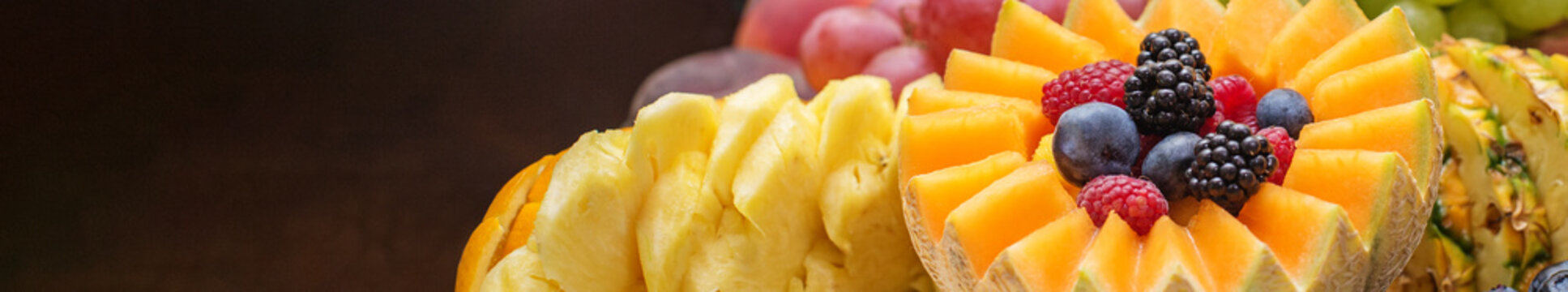 Banner for site. Exotic Fruit Platter Close-Up with Berries and Mango.