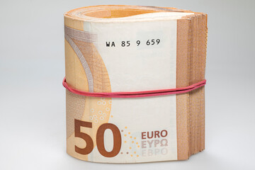 Fifty euro bills banknotes tied with a red rubber band