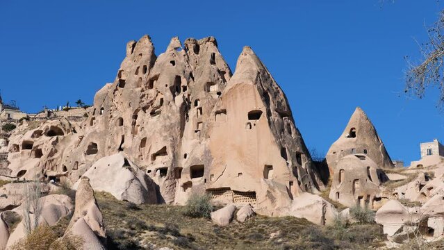View of an old troglodyte settlement in Uchisar. Travel concept for Cappadocia.