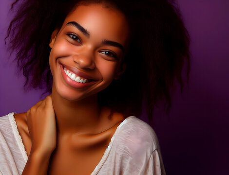 Portrait of a young African American woman with afro hairstyle and white t-shirt on purple background. Women's empowerment.