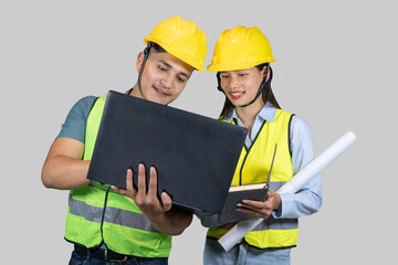 Asian Couple Engineer & Architect gives gestures and expressions on construction field with laptop