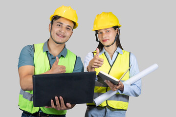 Asian Couple Engineer & Architect gives gestures and expressions on construction field with laptop