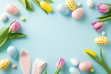 Adorable Spring Wishes Scene: top view of vibrant eggs, playful bunny ears, and blooming tulips on a soft blue backdrop. Ideal for messages or promotions with ample space for text