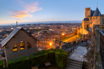 Sunset view overlooking the city and village from inside the medieval fortress and illuminated...