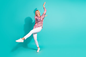 Full size photo of cute girl wear oversize shirt white trousers dancing celebrate black friday isolated on turquoise color background
