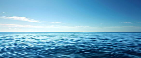 Obraz premium Deep blue ocean waves panorama with sun reflection, clear sky.