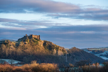 Obraz premium Carreg Cennan Castle, near Llandeilo, south Wales on a frosty winter's morning. The castle is located on a hilltop, overlooking the rural landscape