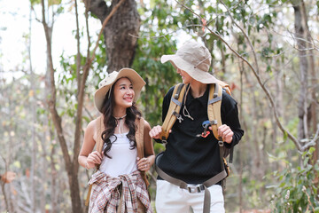 An Asian couple spends their free time on a hiking trip together.