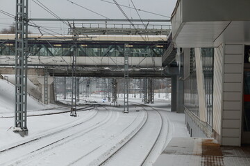 Railroad station in winter. Railway stretching into the distance, bridges.