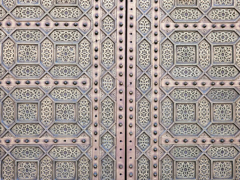 close up view of a traditional Moroccan copper and metal door at the Mohammed V mausoleum in Rabat Morocco