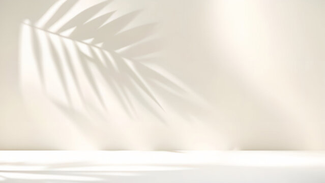 Blurred shadow from palm leaves on light cream wall. Minimalistic beautiful summer spring background for product presentation. © Laura Pashkevich