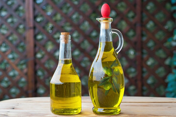 olive oil, extra virgin olive oil in a glass bottle, on a wooden table.
extra virgin olive oil, from organic olive groves in Greece, genuine taste of oil from the Mediterranean.

