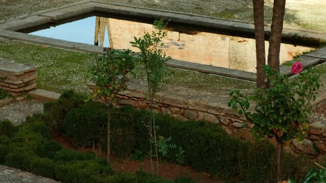 The Alhambra Palace - Palace of Partal displaying exquisite Moorish architecture, lush vegetation and reflective pools, Granada, Andalucia, Spain